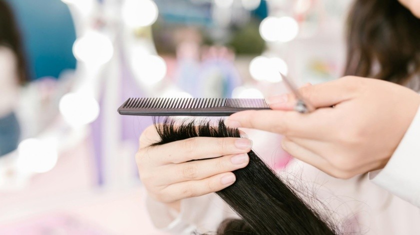 El corte de cabello ayuda a eliminar las puntas dañadas, sino que también estimula un crecimiento más fuerte y vigoroso.(UNSPLASH)